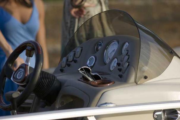 The fiberglass-reinforced console features a tinted windscreen, tilt steering, illuminated rocker switches and full instrumentation. - Photo 5
