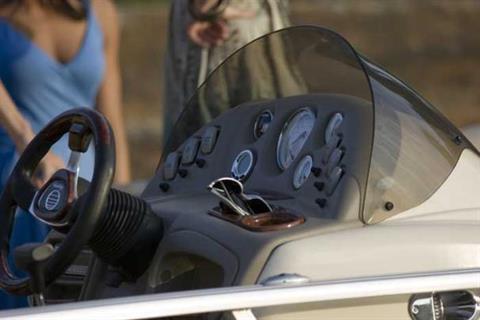 The fiberglass-reinforced console features a tinted windscreen, tilt steering, illuminated rocker switches and full instrumentation. - Photo 5